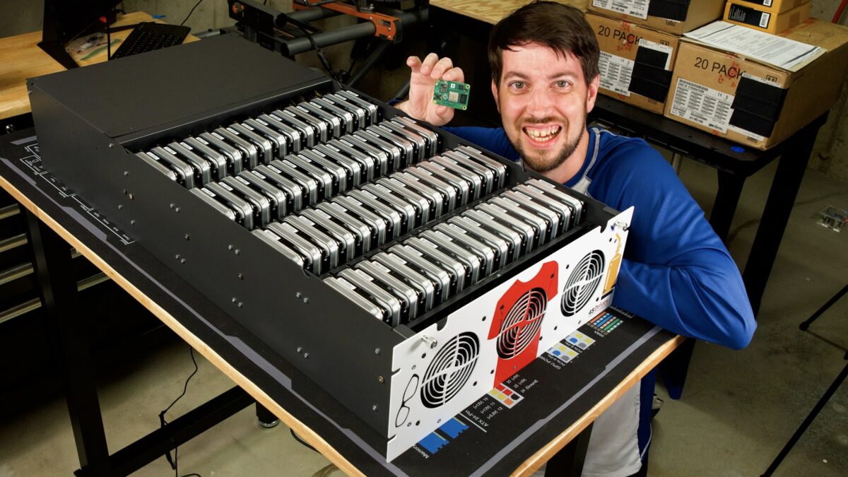 Jeff Geerling at his workbench with a 3D printer, from his Raspberry Pi magazine profile