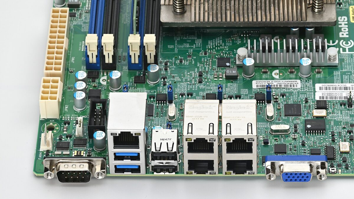 Rear input/output panel of a Supermicro server motherboard, showing the dedicated management Ethernet jack next to the two data network ports, USB, serial and VGA connectors.