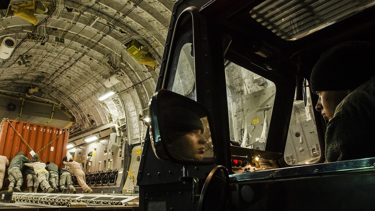 Cargo loader moving freight onto an aircraft, a stand-in for the software supply chain