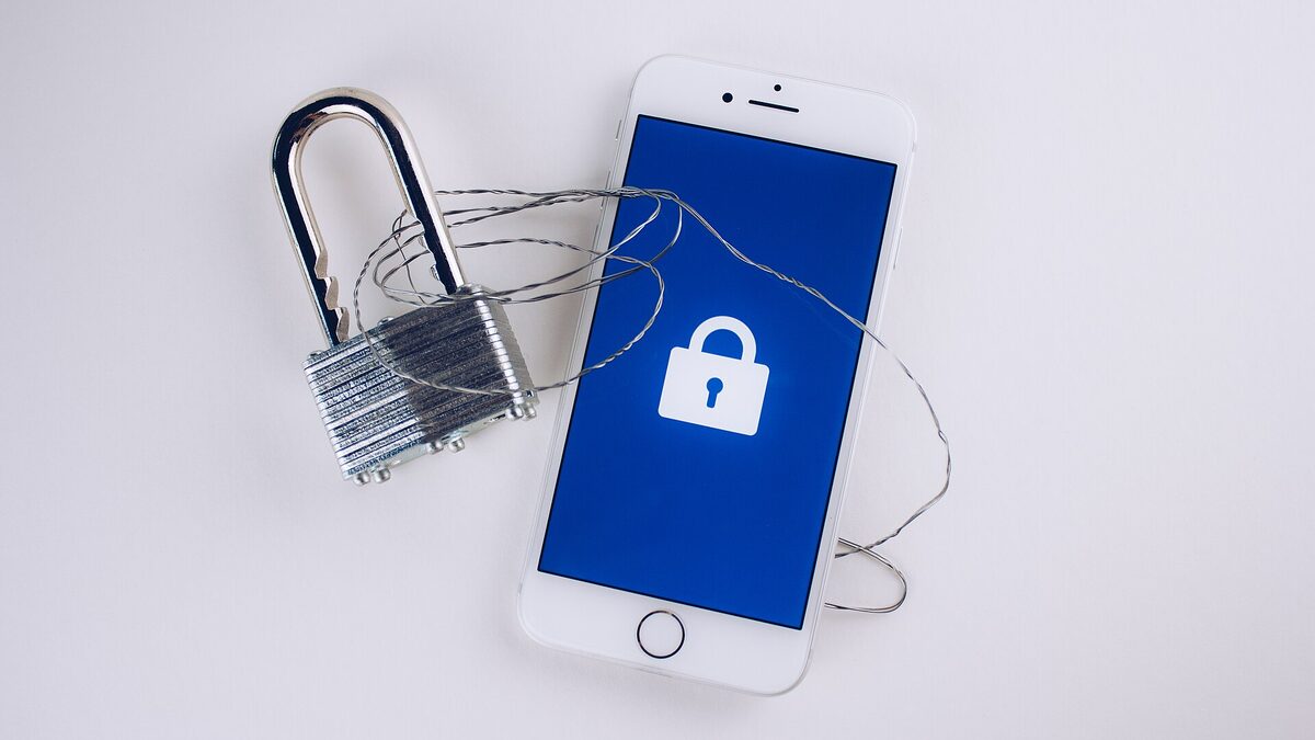 A padlock chained to a smartphone displaying a lock icon, illustrating data privacy.