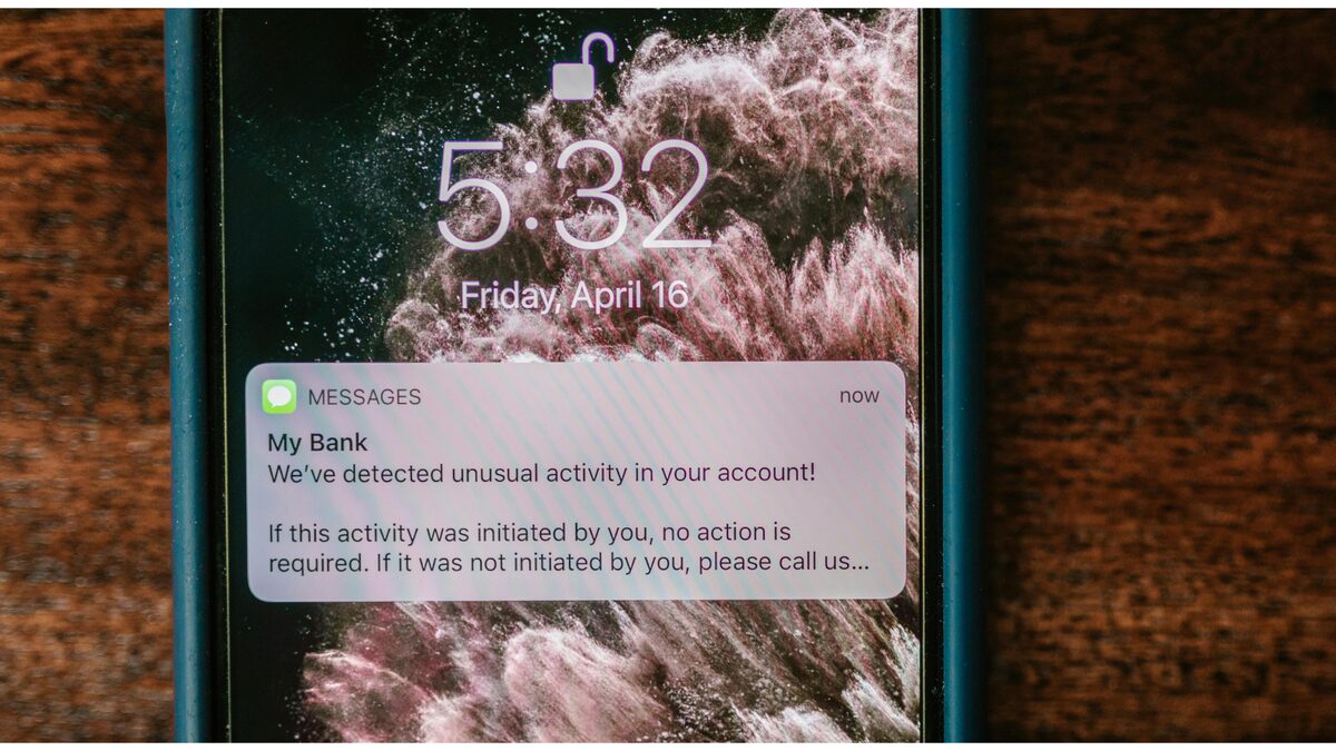 A car driving past a city skyline at night, illustrating mobile cybercrime.